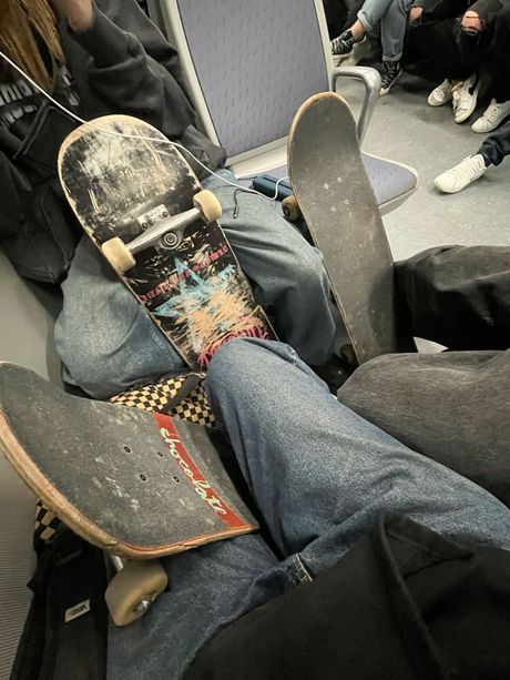 Three skateboards on a train